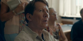 Movie still from “Another Round” (2020), directed by Thomas Vinterberg – An older man and a woman sitting in a room together; Close Up shot, Over the shoulder angle