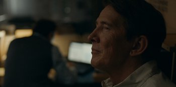 Movie still from “Another Round” (2020), directed by Thomas Vinterberg – A person looking up at a computer screen; Close Up shot, Over the shoulder angle