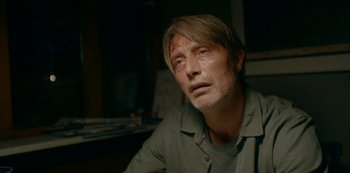 Movie still from “Another Round” (2020), directed by Thomas Vinterberg – A person sitting down with his eyes closed; Close Up shot, Low angle