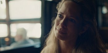 Movie still from “Another Round” (2020), directed by Thomas Vinterberg – A person with long blonde hair; Close Up shot, Over the shoulder angle