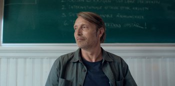 Movie still from “Another Round” (2020), directed by Thomas Vinterberg – A man standing in front of a chalkboard; Close Up shot, Low angle