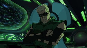 Movie still from “Green Lantern: Beware My Power” (2022), directed by Jeff Wamester – A man in a green outfit with his arms crossed; Medium shot, Over the shoulder angle