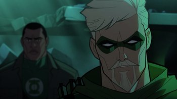 Movie still from “Green Lantern: Beware My Power” (2022), directed by Jeff Wamester – A man with a beard and a green mask is looking at the camera; Close Up shot, Over the shoulder angle