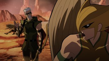 Movie still from “Green Lantern: Beware My Power” (2022), directed by Jeff Wamester – A man with a sword standing next to a woman with long blond hair; Medium shot, Over the shoulder angle