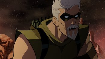Movie still from “Green Lantern: Beware My Power” (2022), directed by Jeff Wamester – An old man with a gray beard wearing a yellow and black outfit; Close Up shot, Over the shoulder angle