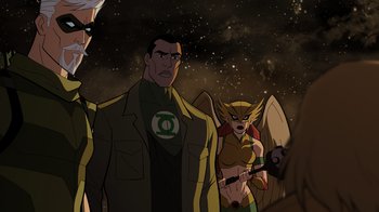 Movie still from “Green Lantern: Beware My Power” (2022), directed by Jeff Wamester – A group of people standing next to each other in front of a space background; Medium shot, Over the shoulder angle