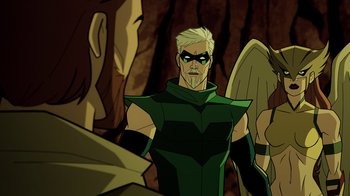 Movie still from “Green Lantern: Beware My Power” (2022), directed by Jeff Wamester – A man in a green outfit is looking at another man in a black suit; Medium shot, Over the shoulder angle
