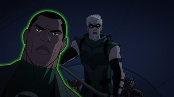 Movie still from “Green Lantern: Beware My Power” (2022), directed by Jeff Wamester – A man with a green arrow in the middle of a scene; Close Up shot, Over the shoulder angle
