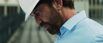 Movie still from “Greenland” (2020), directed by Ric Roman Waugh – A person wearing a hat; Close Up shot, Low angle