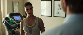 Movie still from “Greenland” (2020), directed by Ric Roman Waugh – A woman standing next to a mirror in a room; Close Up shot, Over the shoulder angle