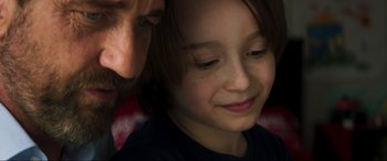 Movie still from “Greenland” (2020), directed by Ric Roman Waugh – A young girl and a man looking at each other; Close Up shot, Over the shoulder angle