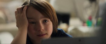 Movie still from “Greenland” (2020), directed by Ric Roman Waugh – A young boy's face; Close Up shot, Over the shoulder angle
