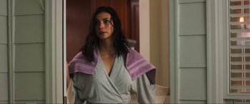 Movie still from “Greenland” (2020), directed by Ric Roman Waugh – A woman wearing a robe and a towel around her shoulders; Medium shot, Over the shoulder angle