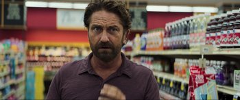 Movie still from “Greenland” (2020), directed by Ric Roman Waugh – A person in a grocery store; Close Up shot, Over the shoulder angle