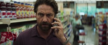 Movie still from “Greenland” (2020), directed by Ric Roman Waugh – A person talking on a cell phone; Close Up shot, Low angle