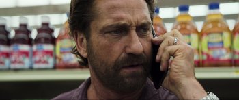 Movie still from “Greenland” (2020), directed by Ric Roman Waugh – A person talking on a cell phone; Close Up shot, Low angle