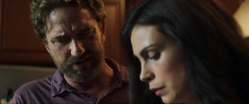 Movie still from “Greenland” (2020), directed by Ric Roman Waugh – A man and a woman looking at one another; Close Up shot, Over the shoulder angle