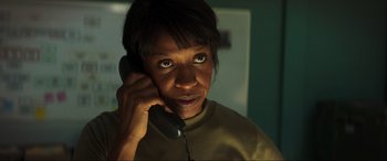 Movie still from “Greenland” (2020), directed by Ric Roman Waugh – A woman is talking on a phone in the dark; Close Up shot, Low angle