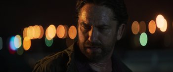 Movie still from “Greenland” (2020), directed by Ric Roman Waugh – A person wearing a shirt; Close Up shot, Over the shoulder angle