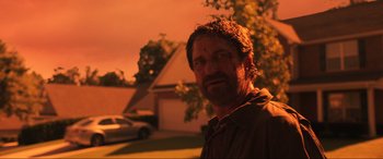 Movie still from “Greenland” (2020), directed by Ric Roman Waugh – A person outside in the dark; Close Up shot, Low angle