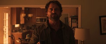 Movie still from “Greenland” (2020), directed by Ric Roman Waugh – A person in a room; Medium shot, Low angle