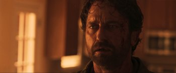 Movie still from “Greenland” (2020), directed by Ric Roman Waugh – A man's face in a dark room; Close Up shot, Over the shoulder angle