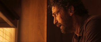 Movie still from “Greenland” (2020), directed by Ric Roman Waugh – A person looking down at his face; Close Up shot, Over the shoulder angle