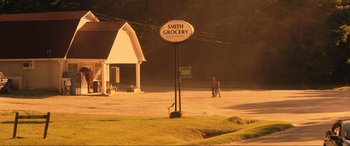 Movie still from “Greenland” (2020), directed by Ric Roman Waugh – A street sign on the side of the road; Extreme Wide shot, High angle