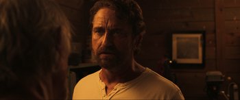 Movie still from “Greenland” (2020), directed by Ric Roman Waugh – A person wearing a white t - shirt; Close Up shot, Over the shoulder angle