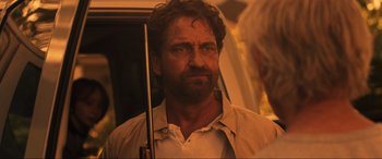 Movie still from “Greenland” (2020), directed by Ric Roman Waugh – A person holding a gun; Close Up shot, Over the shoulder angle