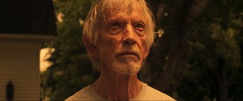 Movie still from “Greenland” (2020), directed by Ric Roman Waugh – An old man with a white beard looking into the distance; Close Up shot, Low angle