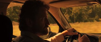 Movie still from “Greenland” (2020), directed by Ric Roman Waugh – A person in a car; Close Up shot, Over the shoulder angle