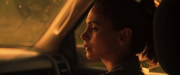 Movie still from “Greenland” (2020), directed by Ric Roman Waugh – A woman with a scar on her face sitting in a car; Close Up shot, Over the shoulder angle