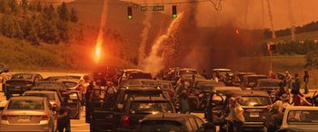 Movie still from “Greenland” (2020), directed by Ric Roman Waugh – A street filled with lots of cars on fire; Extreme Wide shot, High angle