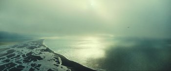 Movie still from “Greenland” (2020), directed by Ric Roman Waugh – A view of the ocean from the beach; Extreme Wide shot, High angle