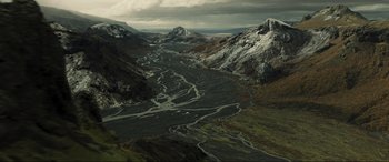 Movie still from “Greenland” (2020), directed by Ric Roman Waugh – An aerial view of a river flowing through a mountain valley; Extreme Wide shot, High angle