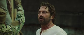 Movie still from “Greenland” (2020), directed by Ric Roman Waugh – A person wearing a white shirt; Close Up shot, Low angle