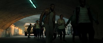 Movie still from “Greenland” (2020), directed by Ric Roman Waugh – A group of people are walking in a tunnel; Wide shot, High angle