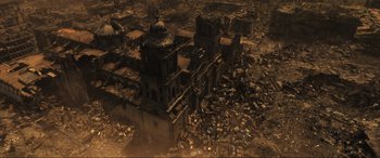 Movie still from “Greenland” (2020), directed by Ric Roman Waugh – An aerial view of an old building in the middle of a destroyed city; Extreme Wide shot, High angle