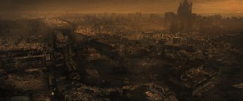 Movie still from “Greenland” (2020), directed by Ric Roman Waugh – An aerial view of a city with a lot of smoke coming out of it; Extreme Wide shot, High angle