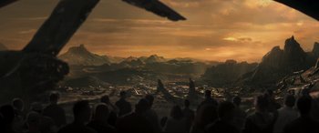 Movie still from “Greenland” (2020), directed by Ric Roman Waugh – A group of people sitting in front of mountains; Extreme Wide shot, High angle