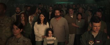 Movie still from “Greenland” (2020), directed by Ric Roman Waugh – A group of people standing in front of a crowd; Wide shot, High angle