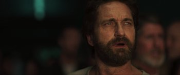 Movie still from “Greenland” (2020), directed by Ric Roman Waugh – A person with a beard; Close Up shot, Low angle