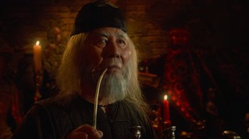 Movie still from “Gremlins” (1984), directed by Joe Dante – An old man with long white hair and a long white beard; Close Up shot, Low angle