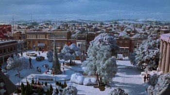Movie still from “Gremlins” (1984), directed by Joe Dante – A snowy scene of a town with a christmas tree; Extreme Wide shot, High angle