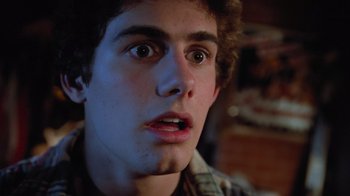Movie still from “Gremlins” (1984), directed by Joe Dante – A person with a surprised look on his face; Close Up shot, Low angle