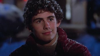 Movie still from “Gremlins” (1984), directed by Joe Dante – A young man wearing a sweater and a jacket; Close Up shot, Low angle