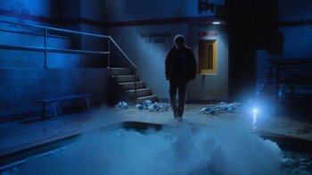 Movie still from “Gremlins” (1984), directed by Joe Dante – A person walking in a room with a lot of snow; Wide shot, Low angle
