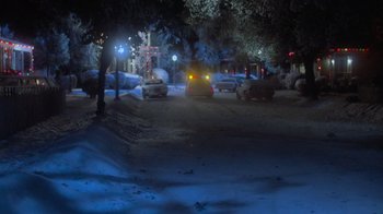 Movie still from “Gremlins” (1984), directed by Joe Dante – Cars parked on the side of the road at night; Extreme Wide shot, High angle