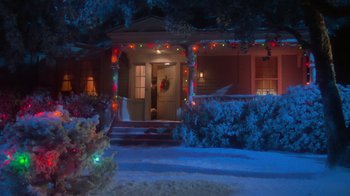 Movie still from “Gremlins” (1984), directed by Joe Dante – A house decorated for the christmas holidays at night; Extreme Wide shot, High angle